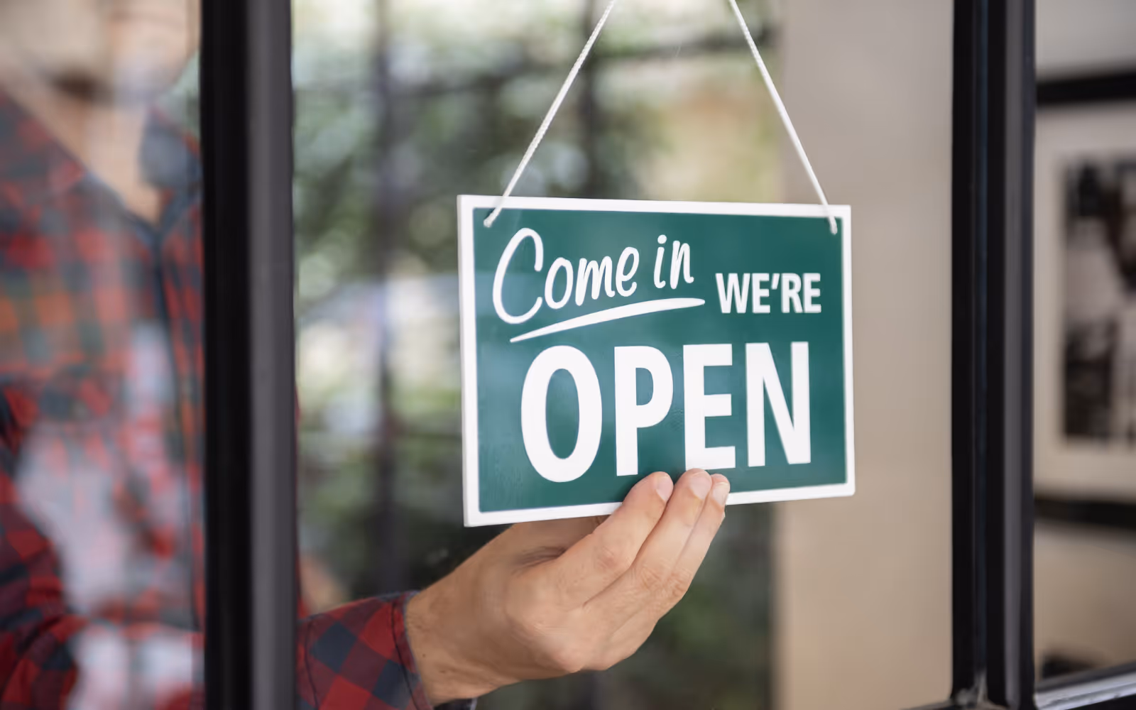 Open sign displayed in a restaurant window, signaling that the business is ready to serve customers.
